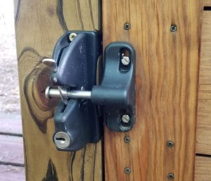 Outdoor lock for gates and doors, Lokklatch on swinging door image Lokklatch outdoor gate lock with keys, shown on wooden door image